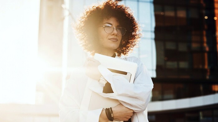 Junge Frau mit Brille und Laptop