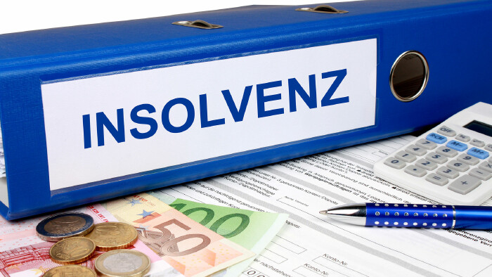 Insolvenz Ordner mit Geld und Taschenrechner