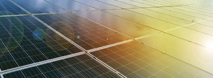 Photovoltaic panels installed on the toproof of the building, sunstainable energy concept. Selective and soft focus.