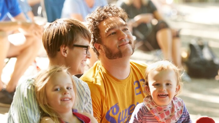  Eine vierk&ouml;pfige junge Familie genie&szlig;t ein Musikfestival im Freien.